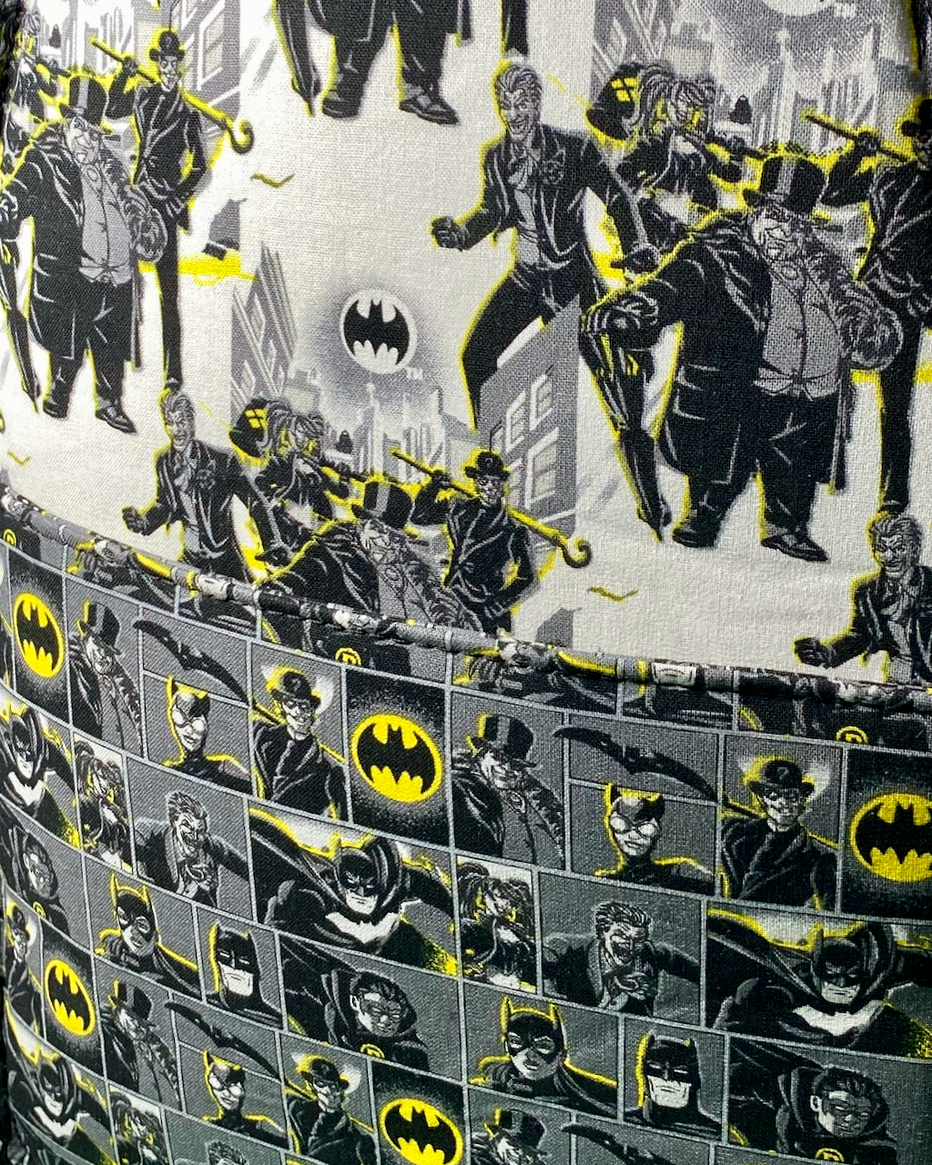 Close-up of slip pocket inside of a Gotham-themed bag, featuring two prints, one exclusively of Gotham villains and the other with both villains and the hero.