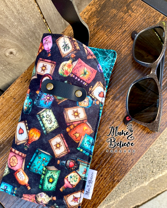 Tossed Witchy Books on Black Glasses Sleeve