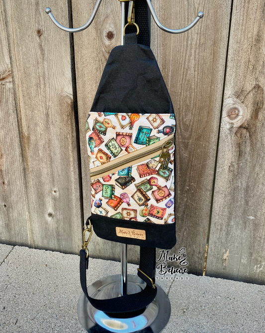 Black and Tan Tossed Witchy Books Mini Traveler Sling