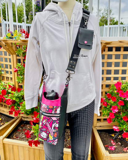 Mannequin wearing a white hoodie with a colorful "Bow Kitty" water bottle carrier in an outdoor setting with flowers and wooden lattice.
