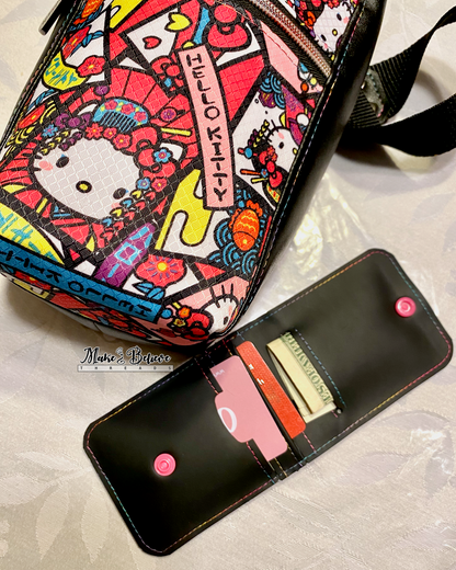 Colorful "Bow Kitty" water bottle carrier laying on table next to an open black jelly vinyl wallet showing cards and cash on a light background