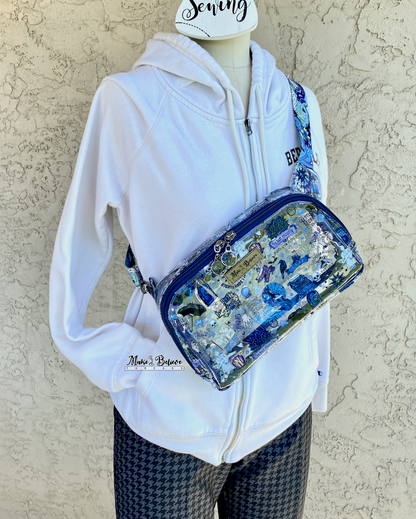 Mannequin with a transparent pack with blue accents and a Wednesday icons worn across the chest, photographed on a neutral background.