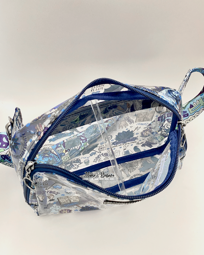 Top view of a transparent hip pack with blue accents showing the depth of the bag and its blue binding, photographed on a white background.