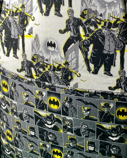 Close-up of slip pocket inside of a Gotham-themed bag, featuring two prints, one exclusively of Gotham villains and the other with both villains and the hero.