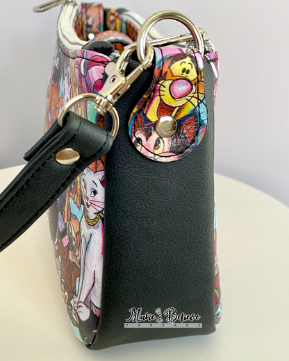 Side view of a shoulder bag with a fussy-cut tiger face on the bag connector, photographed on white background.