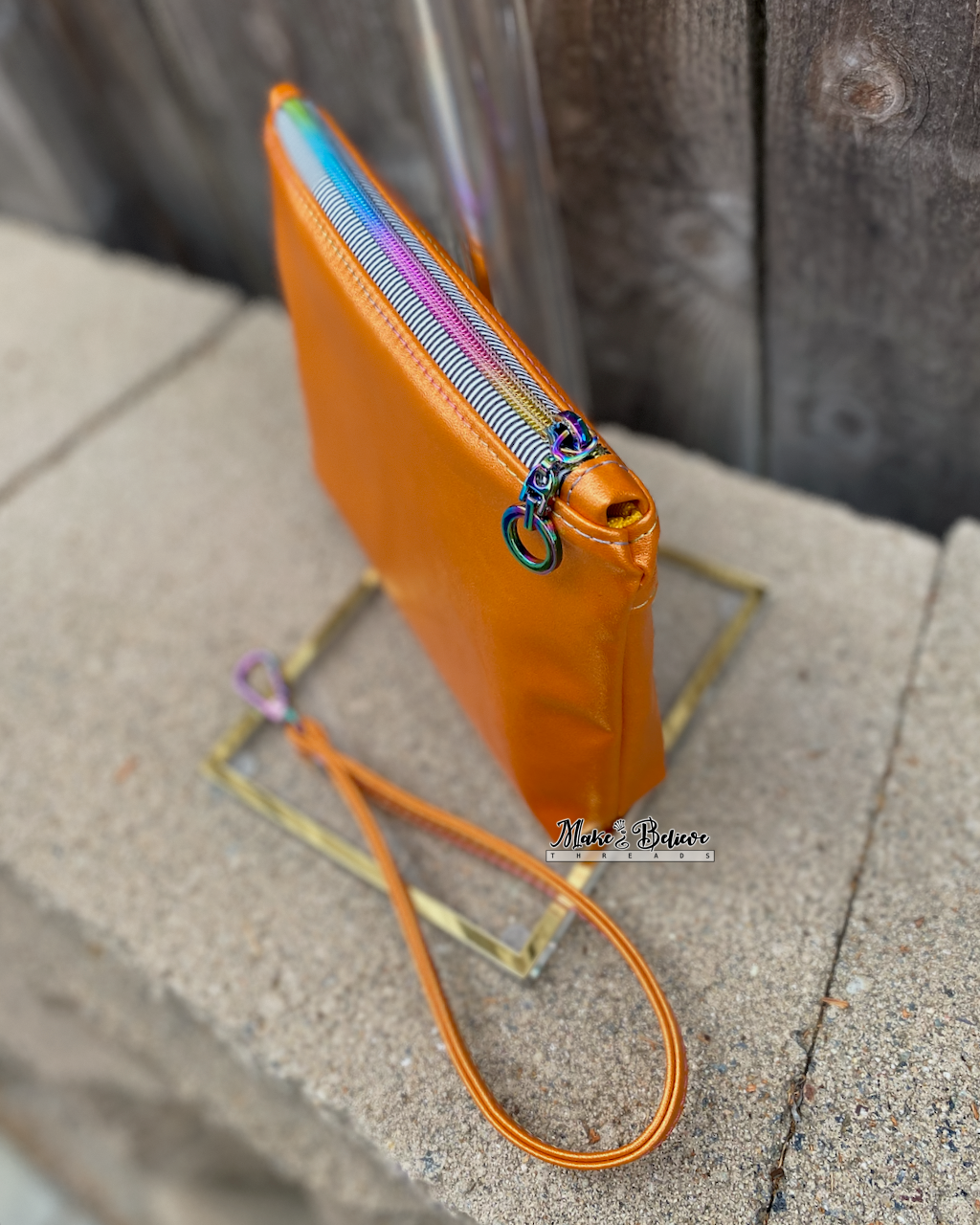 Little Monsters Orange Shimmering Pouch with Wristlet Strap