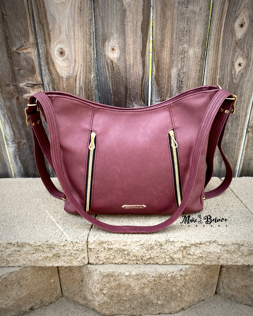 Sleek Bordeaux Convertible Bag with Gold Hardware