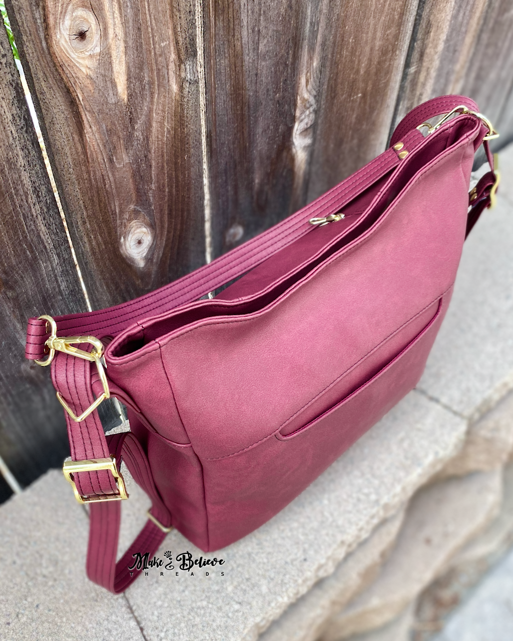 Sleek Bordeaux Convertible Bag with Gold Hardware