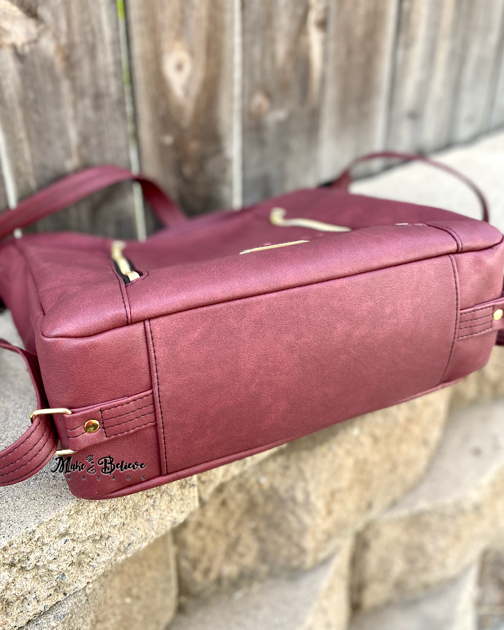 Sleek Bordeaux Convertible Bag with Gold Hardware