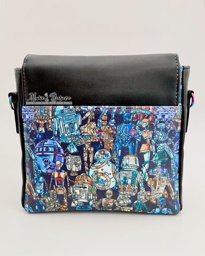 Back of a black faux leather bag with space wars droids printed vinyl panel on a light gray background