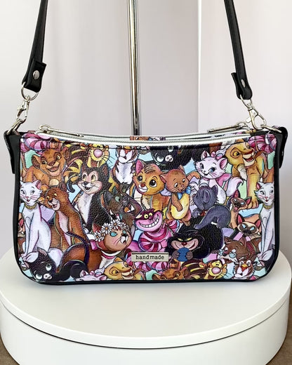 Video of a cartoon cat shoulder bag as it rotates on a turntable, showing all four sides.